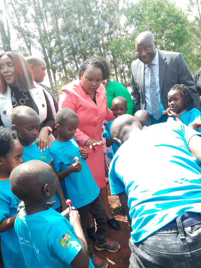 CS Bore and PS Motari plants a tree with Children during the World Children's Day